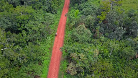 aerial of a motorcycle on a dirt road in mukono, uganda
