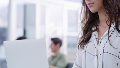 a-young-businesswoman-using-a-laptop-at-her-desk