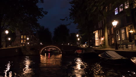 Timelapse-view-of-cityscape-during-river-cruise-at-night-Amsterdam-Netherlands