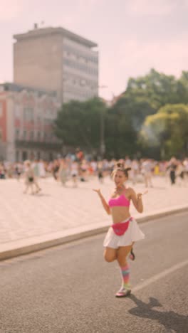 young woman celebrating in city street