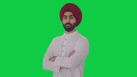 Portrait-of-Confident-Sikh-Indian-man-standing-crossed-hands-Green-screen