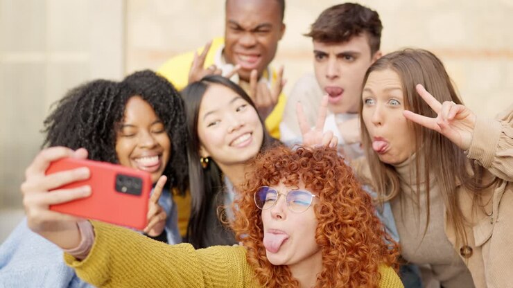 Diverse friends taking a selfie and smiling in the city