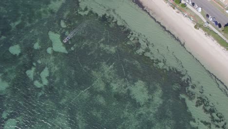 Flying-Above-Clear-Blue-Sea-At-The-Beach-Of-Shoal-Bay