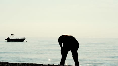 active young man doing physical exercise near ocean. man doing exercise for body