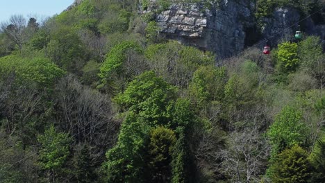 great orme suspended cable car moving along scenic llandudno mountain aerial view