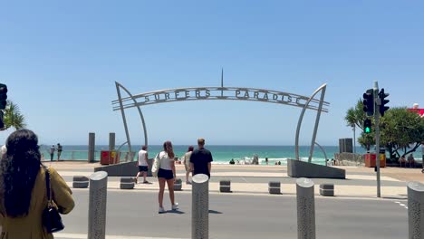 people walking near iconic beach entrance