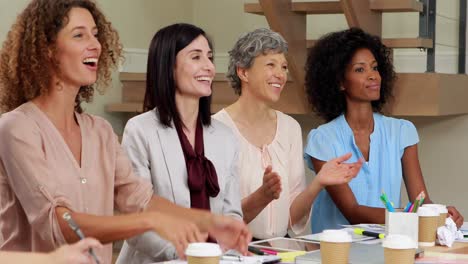 mujeres felices aplaudiendo en la oficina