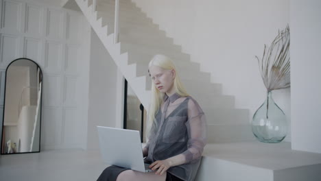 woman working on laptop in a modern home