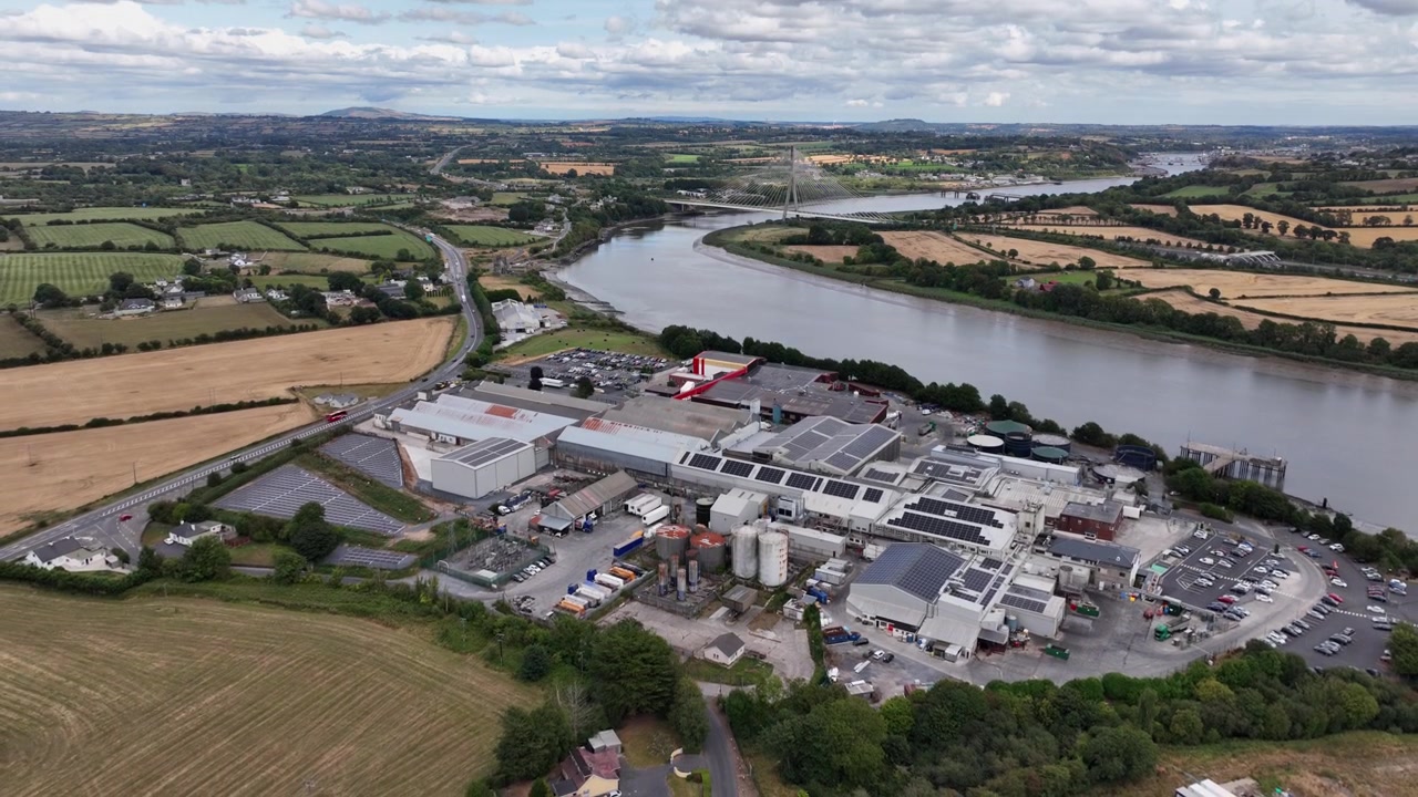 aerial pullback overview of meat processing plant Grannagh Kilkenny with Thomas Francis Meagher Bridge The River Suir and Waterford City in Background, busy plant serving the meat industry Ireland