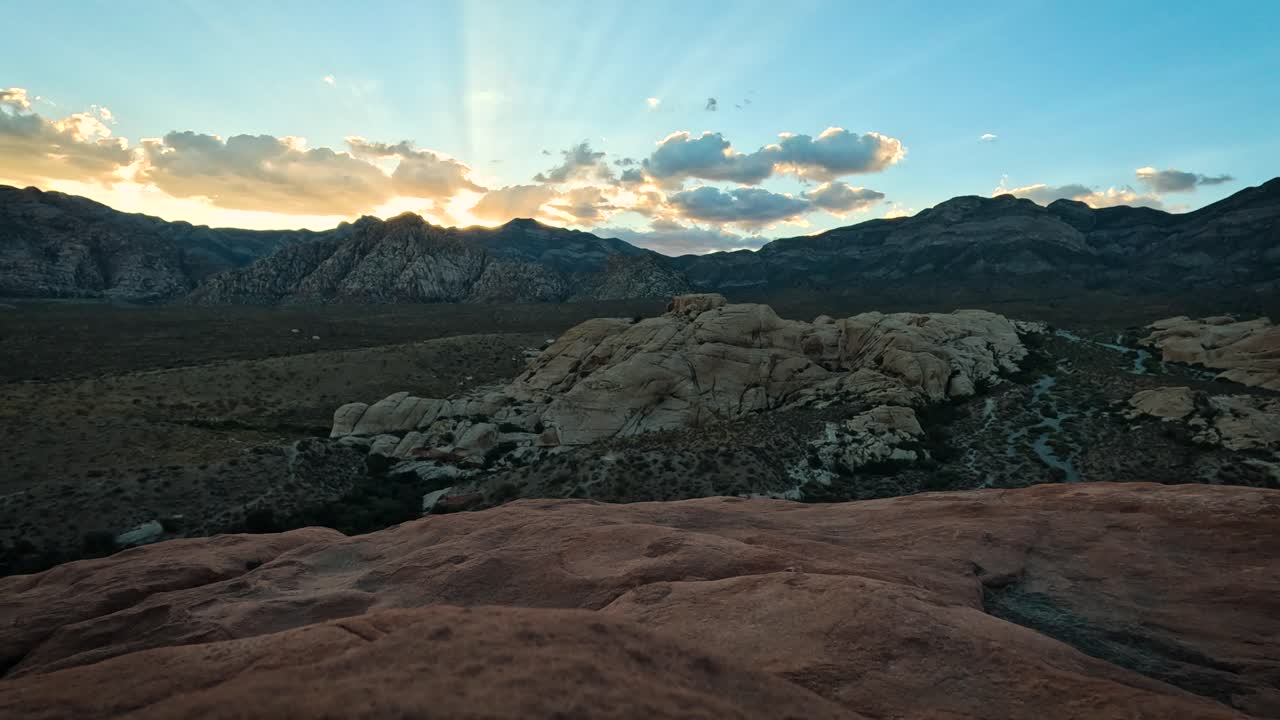 Time lapse light rays shine under a cloud