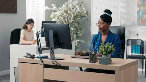 busy afternoon at the office, accounting department, marketing, two elegant women work in front of the company's computers, create documents, plan strategy, click their fingers on the keyboard