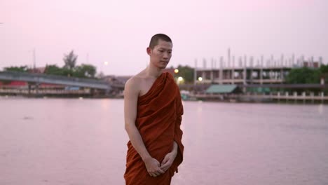 The-monks-were-walking-distracted-near-the-water-with-calm-conditions