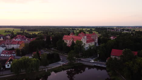 Rising-over-historic-town-with-a-majestic-castle-and-many-old-buildings