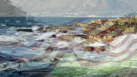 digital composition of waving us flag against sea waves hitting the rocks