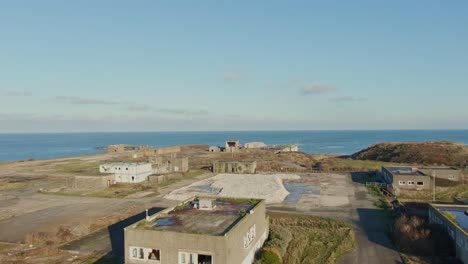 reveal-shot-of-abandoned--buildings-on-the-coast