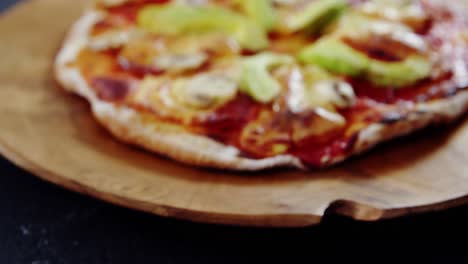 baked pizza with avocado and mushroom toppings