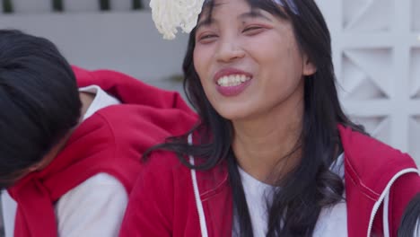 happy young asian people participating crackers eating competition called lomba makan kerupuk to celebrate indonesian independence day