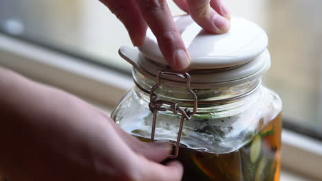 closing a jar of fresh pickles