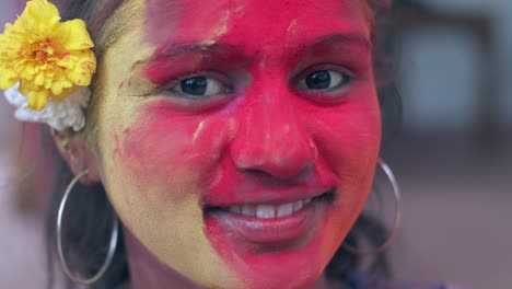 indian women close-up of face smeared with bright holi colors