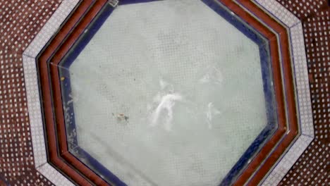 drone flying and rotating over a fountain