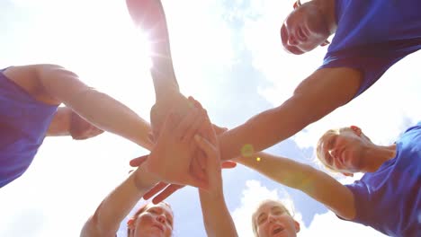 fit people forming hands stack in boot camp 4k