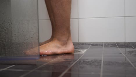 man feet entering in the shower cabin - skin care at home