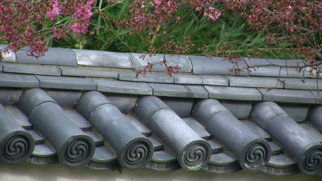 wall tiles with plum tree branches and blossoms blowing in the breeze