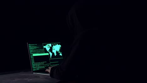 hacker using laptop computer hacking in the dark room