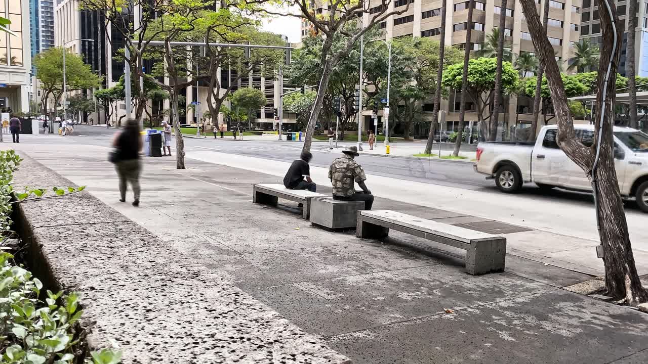 Timelapse of commuters waiting at a bus stop in downtown Honolulu