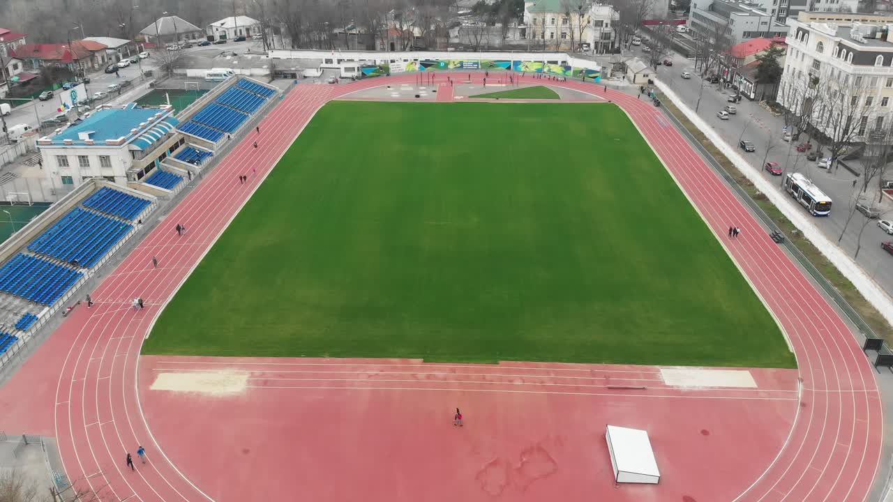 Aerial view of a stadium with a running track and a green field