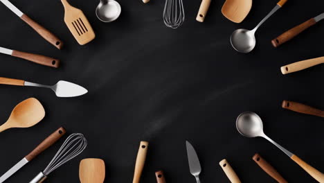 kitchen utensils flat lay on black background