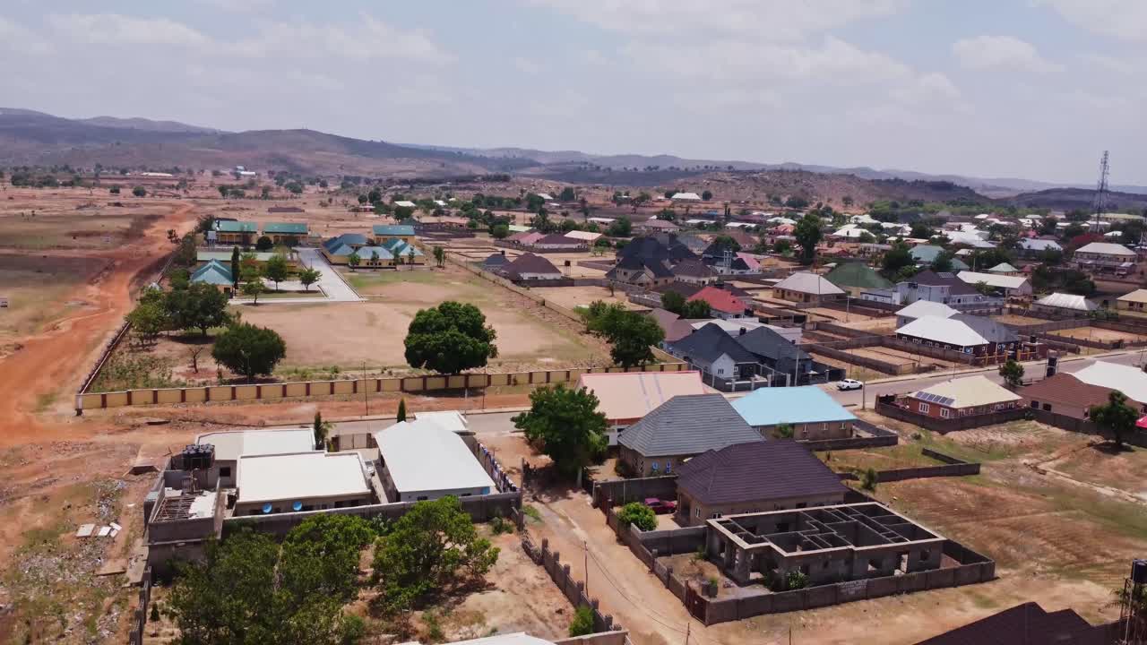 Jib down of an idyllic small town in rural Nigeria on a sunny day