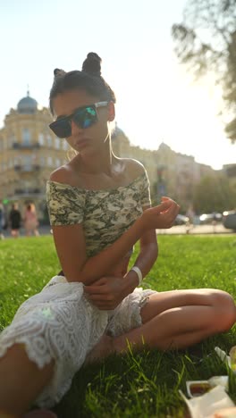 young woman enjoying a meal in the park