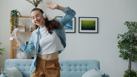 woman dancing at home with headphones and microphone
