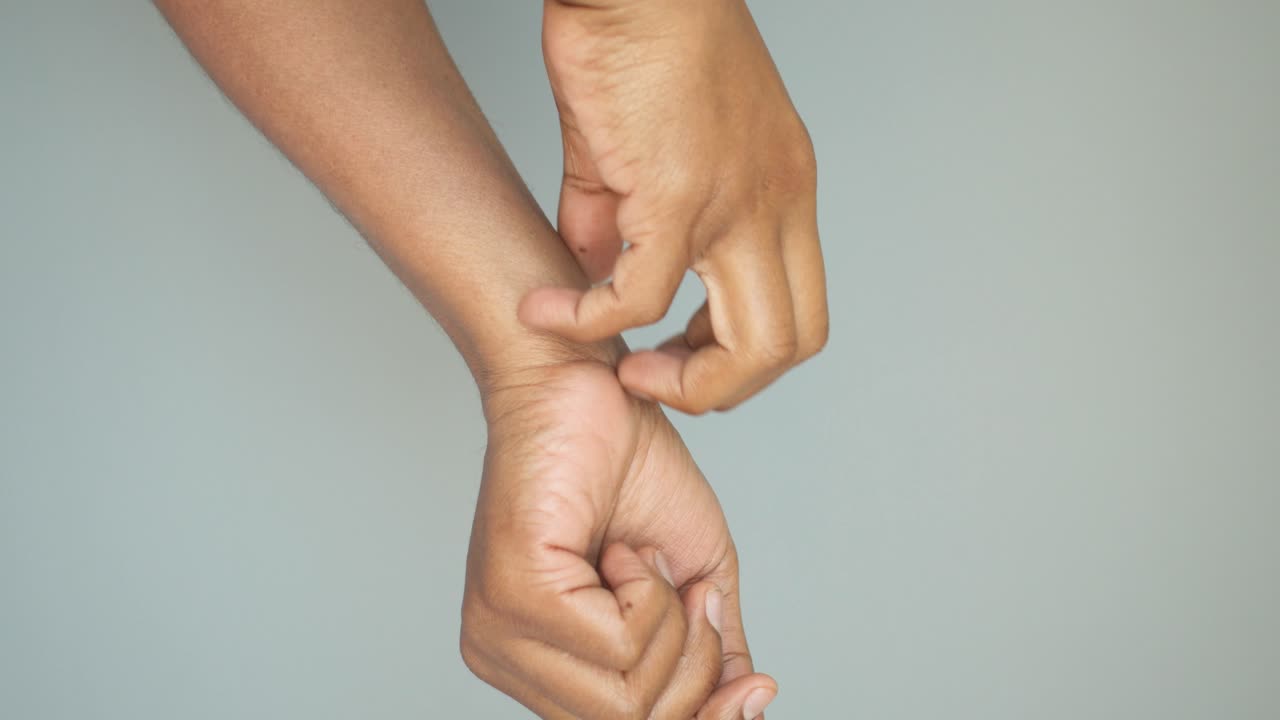 Person scratching their itchy skin