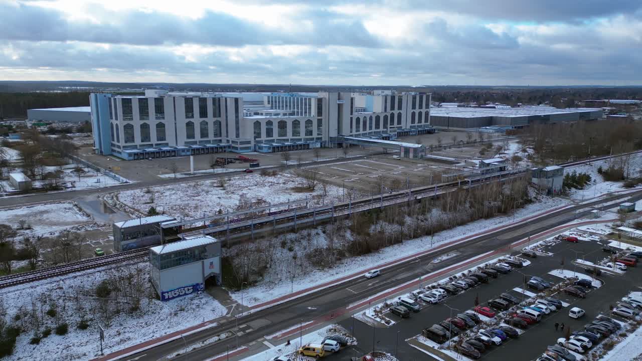train traveling through a snowy cityscape in segefeld Falkensee. Stunning aerial view flight panorama orbit drone