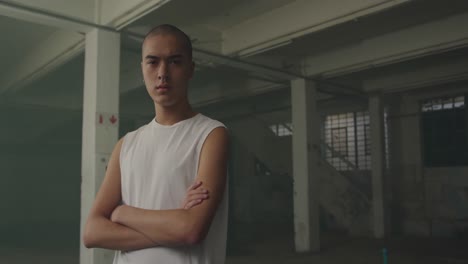 fashionable young man in an abandoned warehouse