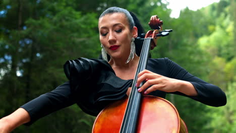 portrait of woman playing cello. woman performing music on cello outdoor