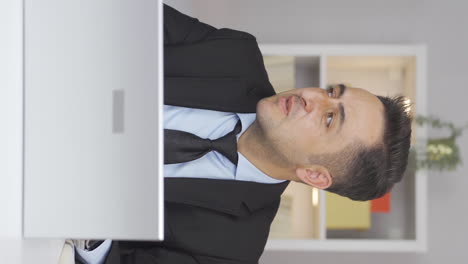 Vertical-video-of-Home-office-worker-man-getting-angry.