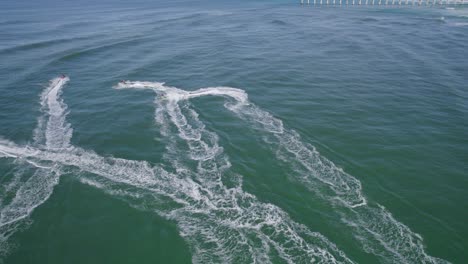 Letitia-Beach-With-Jet-Skis-Playing-On-The-Water-In-NSW,-Australia---aerial-drone-shot