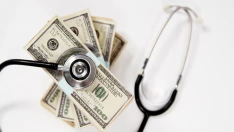 Stack-bundles-of-hundred-dollar-currency-with-a-stethoscope