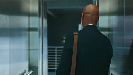 business, man and elevator in office