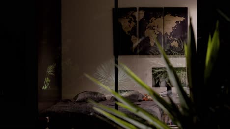 slow revealing shot of a luxury villa bedroom with the world map hanging