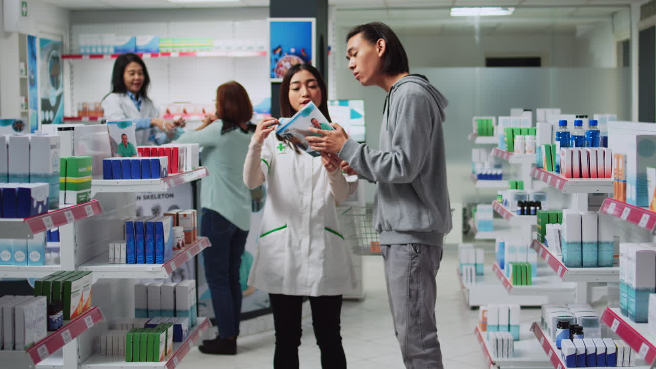 Pharmacist assisting customer at drugstore