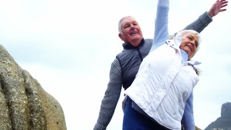 Senior-couple-performing-stretching-exercise