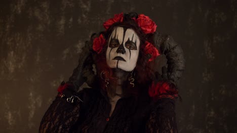 catrina cosplay girl caressing her face with seducing face in a dark background, medium close