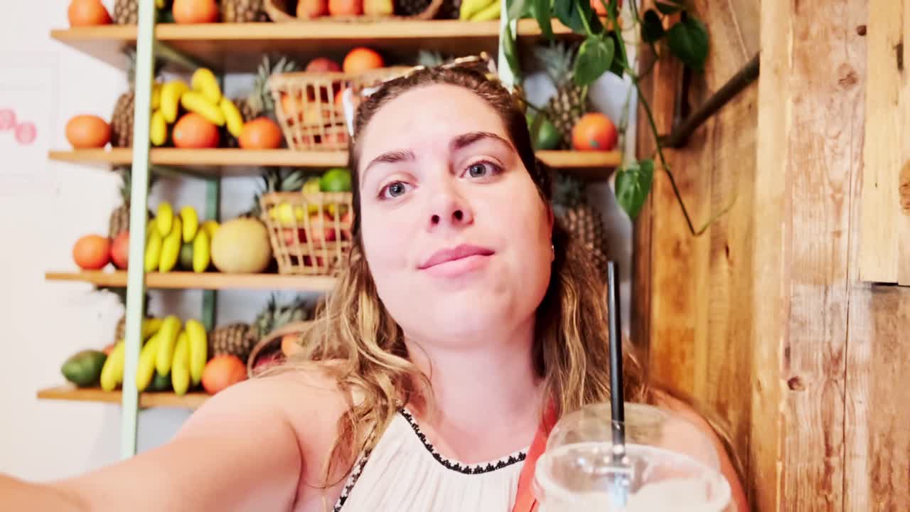 Young Woman Vlogging While Drinking a Smoothie