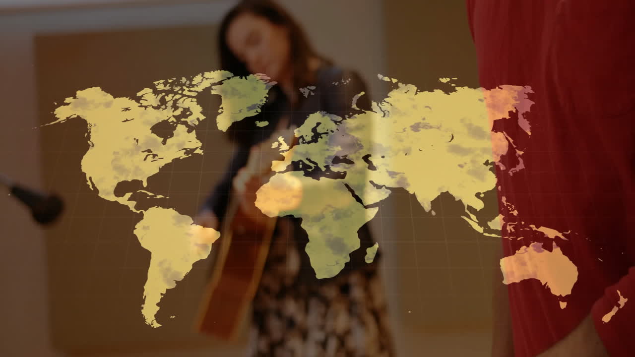 Musician duo presenting music, male speaking while female playing guitar with world map overlay