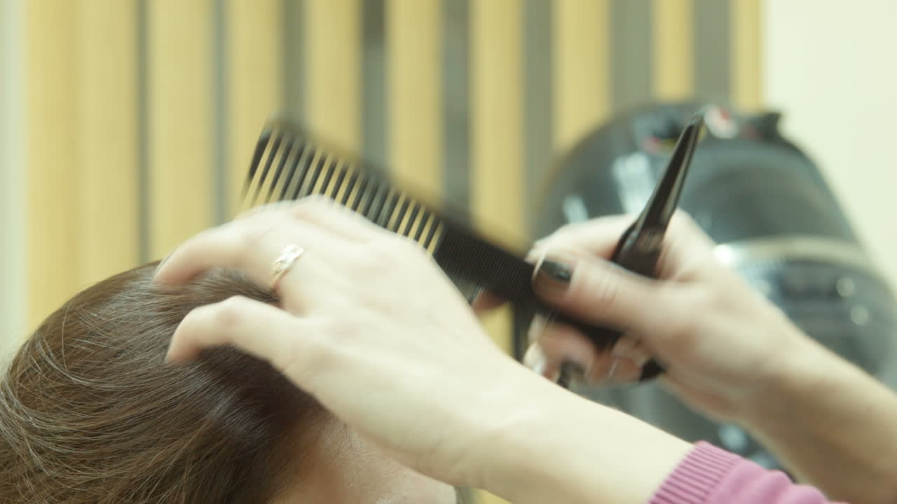 Woman getting a haircut at a salon