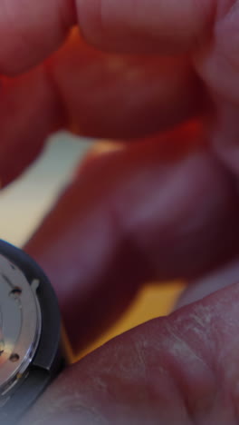 primer plano de las manos de un relojero reparando un reloj